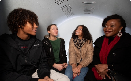 Mom with three teens in Gateway Arch tram